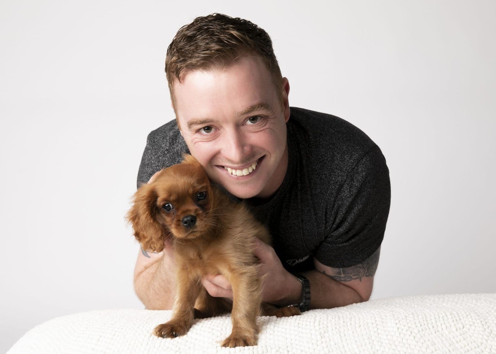 Dean McCarthy with a King Charles spaniel puppy